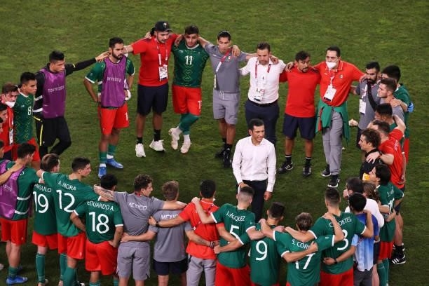 Jaime Lozano, Head Coach of Team Mexico gives his players instructions before the penalty shoot out during the Men's Football Semi-final match...