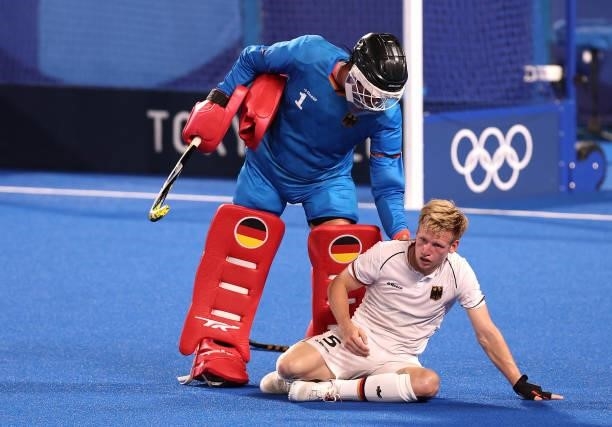 Alexander Stadler of Team Germany checks on teammate Linus Muller of Team Germany during the Men's Semifinal match between Australia and Germany on...
