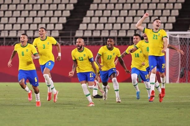 Dani Alves, Malcom, Henrique Matheus, Bruno Guimaraes and Gabriel Martinelli of Team Brazil celebrate their side's victory in the penalty shoot out...