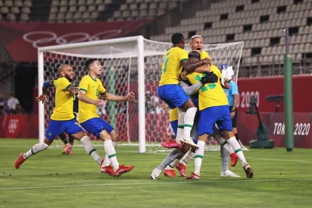 Reinier of Team Brazil celebrates with team mates after scoring their side's winning penalty during the penalty shoot out during the Men's Football...