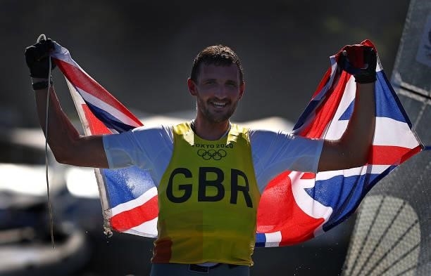 Giles Scott of Team Great Britain celebrates after winning gold in the Men's Finn class on day eleven of the Tokyo 2020 Olympic Games at Enoshima...