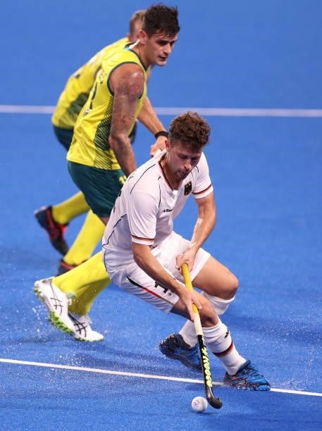 Timm Alexander Herzbruch of Team Germany controls the ball whilst under pressure from Blake Govers of Team Australia during the Men's Semifinal match...