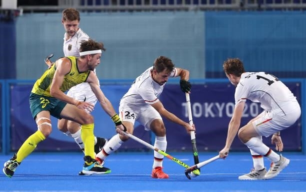 Flynn Andrew Ogilvie of Team Australia battles for possession with Benedikt Furk and Constantin Staib of Team Germany during the Men's Semifinal...