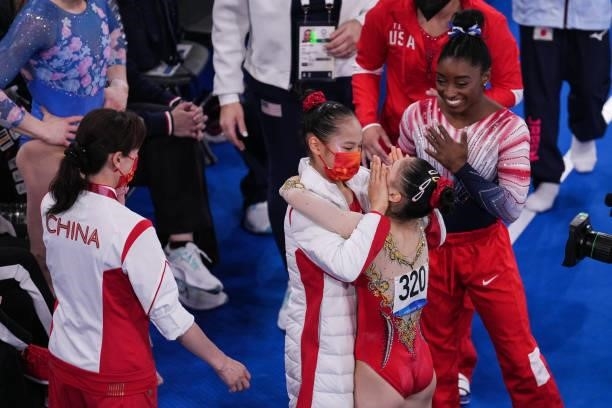 Silver medalist Tang Xijing of Team China, gold medalist Guan Chenchen of Team China and bronze medalist Simone Biles of Team United States react...
