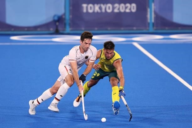 Lukas Windfeder of Team Germany and Tim Brand of Team Australia battle for the ball during the Men's Semifinal match between Australia and Germany on...
