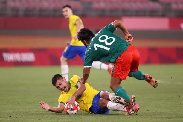 Eduardo Aguirre of Team Mexico is challenged by Bruno Guimaraes of Team Brazil during the Men's Football Semi-final match between Mexico and Brazil...