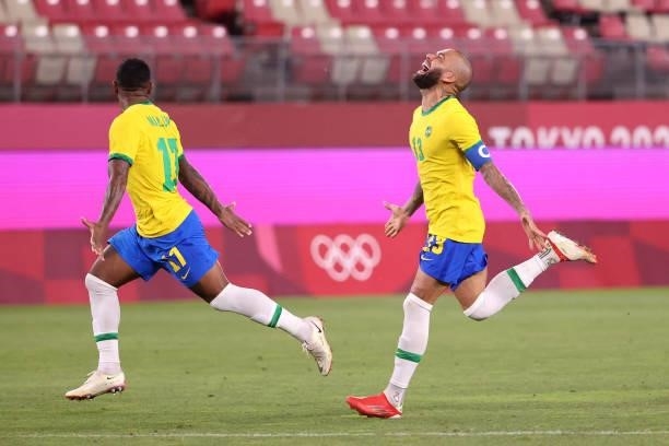Malcom and Dani Alves of Team Brazil celebrate their side's victory in the penalty shoot out after the Men's Football Semi-final match between Mexico...