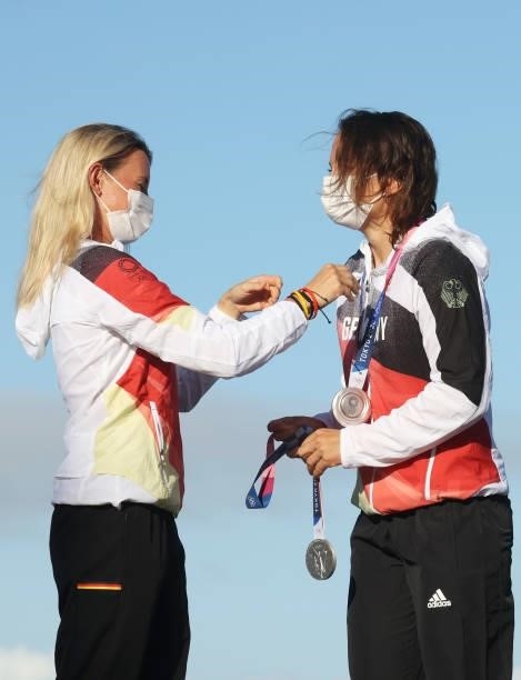 Tina Lutz of Team Germany is presented with her silver medal by team mate Susann Beucke of Team Germany during the podium ceremony for the Women's...