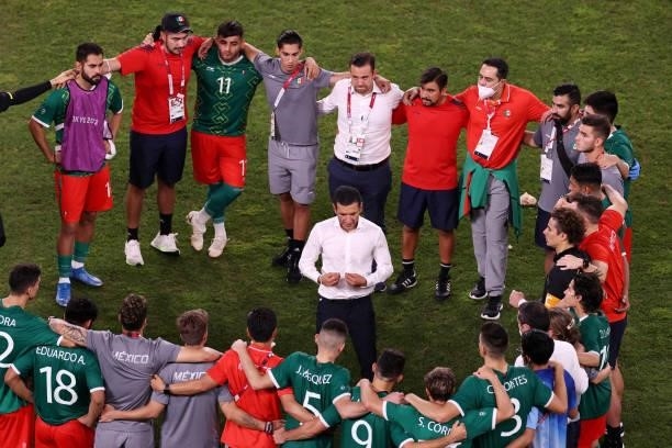 Jaime Lozano, Head Coach of Team Mexico speaks with his players following defeat in the penalty shoot out after the Men's Football Semi-final match...