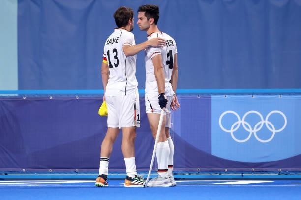 Tobias Constantin Hauke consoles teammate Lukas Windfeder of Team Germany following a loss in the Men's Semifinal match between Australia and Germany...