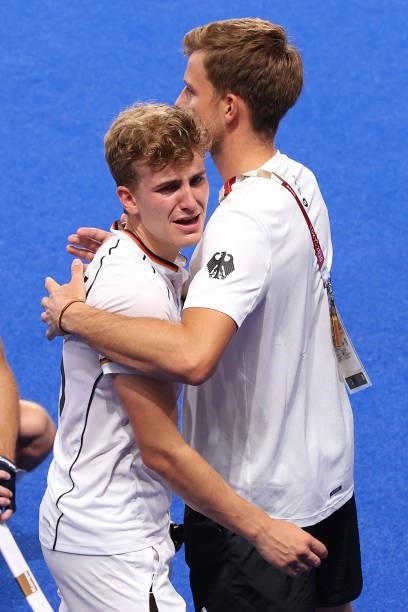 Niklas Bosserhoff of Team Germany is consoled by a Team Germany Member of Staff following a loss in the Men's Semifinal match between Australia and...