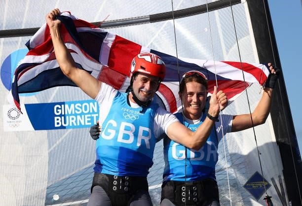 John Gimson and Anna Burnet of Team Great Britain celebrate finishing second in the Nacra 17 Foiling class on day eleven of the Tokyo 2020 Olympic...