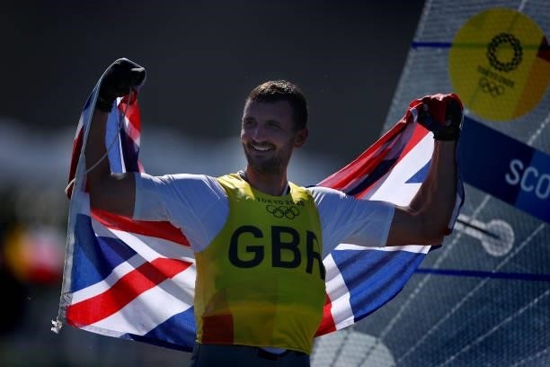 Giles Scott of Team Great Britain celebrates on the podium for the Men's Finn class on day eleven of the Tokyo 2020 Olympic Games at Enoshima Yacht...