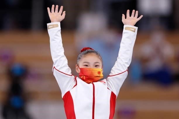 Gold medalist Guan Chenchen of Team China celebrates on the podium after the Women's Balance Beam Final on day eleven of the Tokyo 2020 Olympic Games...