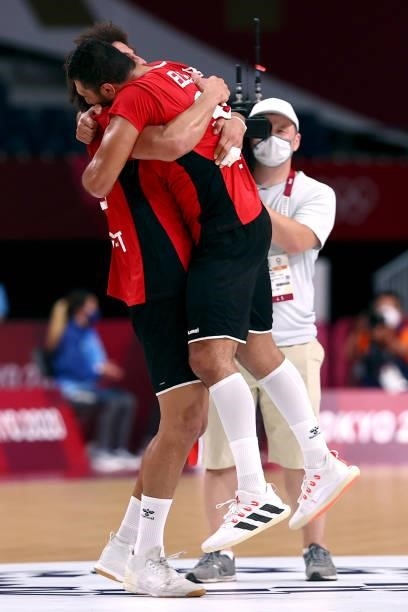 Ali Mohamed and Yehia Elderaa of Team Egypt embrace each other after winning the Men's Quarterfinal handball match between Germany and Egypt on day...