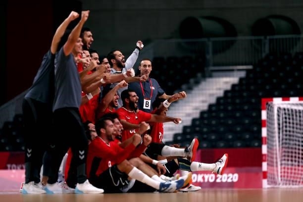 Roberto Parrondo , coach of Team Egypt celebrates with his team after winning the Men's Quarterfinal handball match between Germany and Egypt on day...