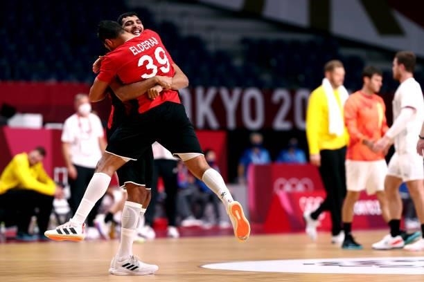 Yehia Elderaa and Seif Elderaa of Team Egypt embrace each other after winning the Men's Quarterfinal handball match between Germany and Egypt on day...