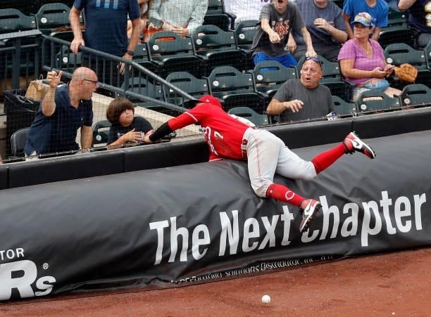 Eugenio Suarez of the Cincinnati Reds can't come up with a foul ball off the bat of Brandon Nimmo of the New York Mets during the sixth inning at...