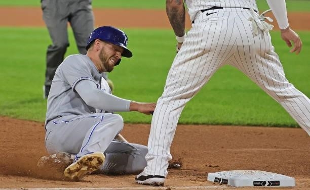 Hunter Dozier of the Kansas City Royals slides into third base with a triple in the 7th inning against the Chicago White Sox at Guaranteed Rate Field...