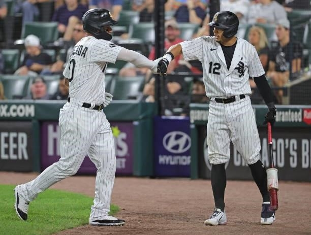 Yoan Moncada of the Chicago White Sox is congratulates by Cesar Hernandez after scoring a run on a bases loaded walk in the 7th inning against the...