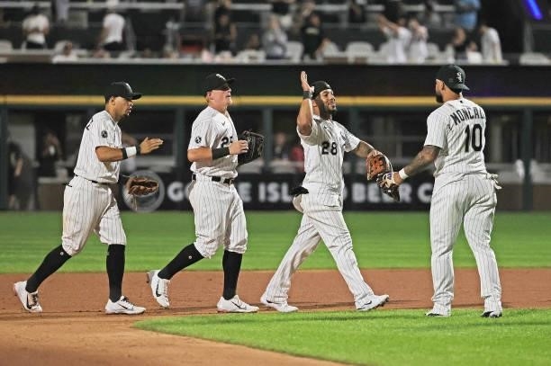 Cesar Hernandez, Andrew Vaughn, Leury Garcia and Yoan Moncada of the Chicago White Sox celebrate a win over the Kansas City Royals at Guaranteed Rate...