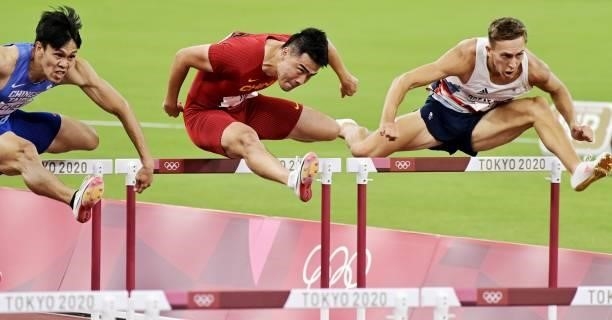 Chen Kuei-Ru of Chinese Taipei, Xie Wenjun of China and David King of Great Britain compete in the Men's 110m Hurdles Round 1 - Heat 4 on day eleven...