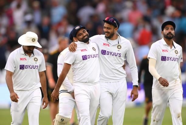 India bowler Mohammed Shami shares a joke with Axar Patel as they leave the field after bowling England out on day one during day one of the First...