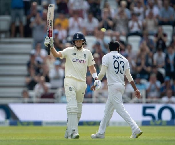Joe Root of England holds his bat aloft after reaching 50 during day one of the First Test Match between England and India at Trent Bridge on August...