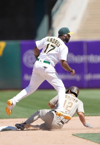 Elvis Andrus of the Oakland Athletics completes the double-play over Adam Frazier of the San Diego Padres at RingCentral Coliseum on August 04, 2021...