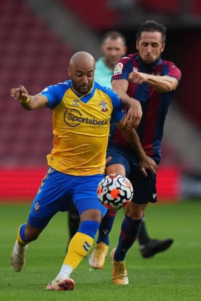 Nathan Redmond of Southamptoni schallenged by Jorge Miramon of Levante during a pre season friendly between Southampton and Levante at St Mary's...