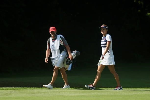 Lexi Thompson of Team United States and caddie Drew Hinesley walk up the 17th hole during the second round of the Women's Individual Stroke Play on...