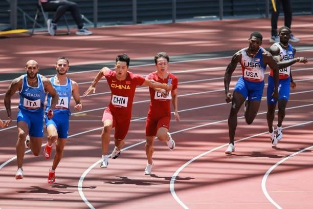 Xie Zhenye and Tang Xingqiang of Team China compete in the Men's 4 x 100m Relay Round 1 - Heat 2 on day thirteen of the Tokyo 2020 Olympic Games at...