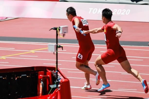 Wu Zhiqiang and Su Bingtian of Team China compete in the Men's 4 x 100m Relay Round 1 - Heat 2 on day thirteen of the Tokyo 2020 Olympic Games at...