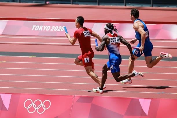 Wu Zhiqiang of Team China, Cravon Gillespie of Team United States and Filippo Tortu of Team Italy compete in the Men's 4 x 100m Relay Round 1 - Heat...