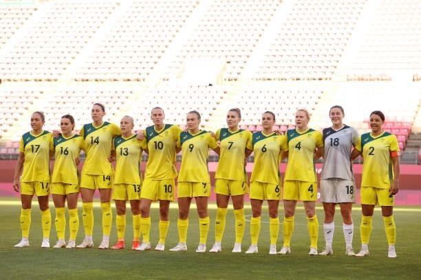 Players of Team Australia stand for the national anthem prior to the Women's Bronze Medal match between United States and Australia on day thirteen...