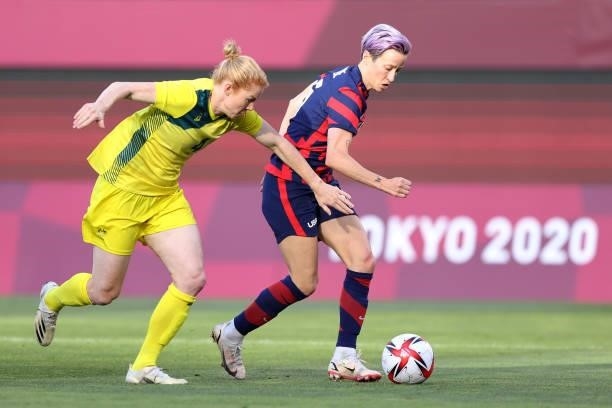 Megan Rapinoe of Team United States runs with the ball whilst under pressure from Clare Polkinghorne of Team Australia during the Women's Bronze...