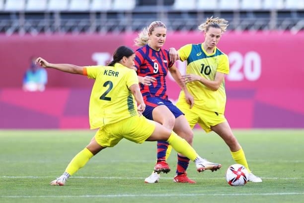 Lindsey Horan of Team United States is challenged by Sam Kerr and Emily Van Egmond of Team Australia during the Women's Bronze Medal match between...