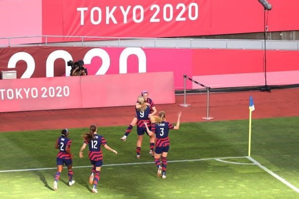 Megan Rapinoe of Team United States celebrates with Lindsey Horan and Samantha Mewis after scoring their side's first goal during the Women's Bronze...
