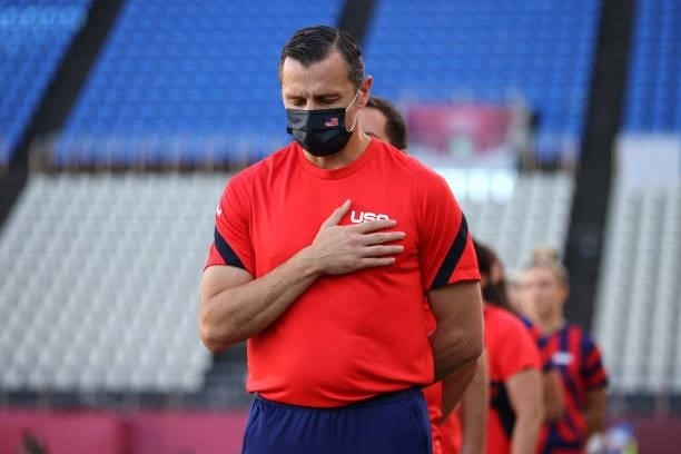 Vlatko Andonovski, Head Coach of Team United States wears a face mask as he stands for the national anthem prior to the Women's Bronze Medal match...