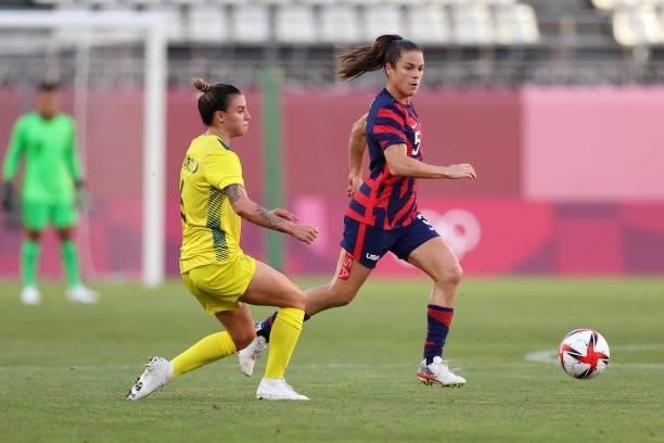 Kelley O'Hara of Team United States runs with the ball whilst under pressure from Chloe Logarzo of Team Australia during the Women's Bronze Medal...