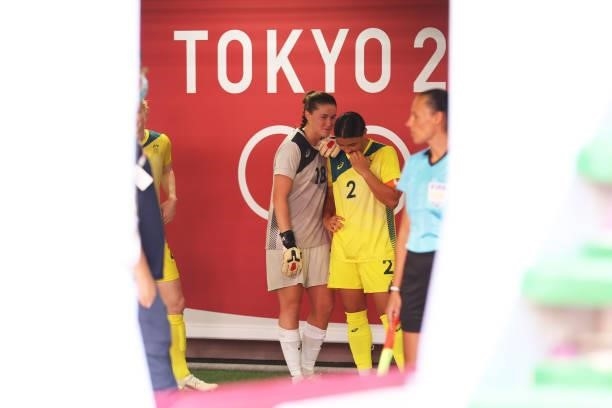 Sam Kerr and Teagan Micah of Team Australia wait to take to the field prior to the Women's Bronze Medal match between United States and Australia on...