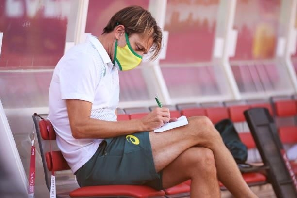 Tony Gustavsson, Head Coach of Australia wears a face mask as he takes notes prior to the Women's Bronze Medal match between United States and...
