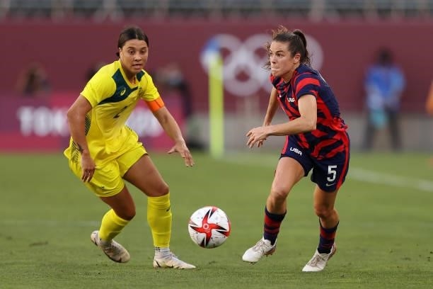 Kelley O'Hara of Team United States runs with the ball whilst under pressure from Sam Kerr of Team Australia during the Women's Bronze Medal match...