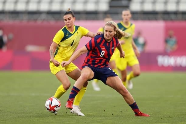 Lindsey Horan of Team United States battles for possession with Chloe Logarzo of Team Australia during the Women's Bronze Medal match between United...