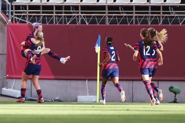 Megan Rapinoe of Team United States celebrates with Lindsey Horan and teammates after scoring their side's first goal during the Women's Bronze Medal...