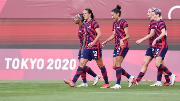 Carli Lloyd of Team United States celebrates with Crystal Dunn and Christen Press after scoring their side's third goal during the Women's Bronze...
