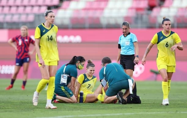 Steph Catley of Team Australia receives medical treatment during the Women's Bronze Medal match between United States and Australia on day thirteen...