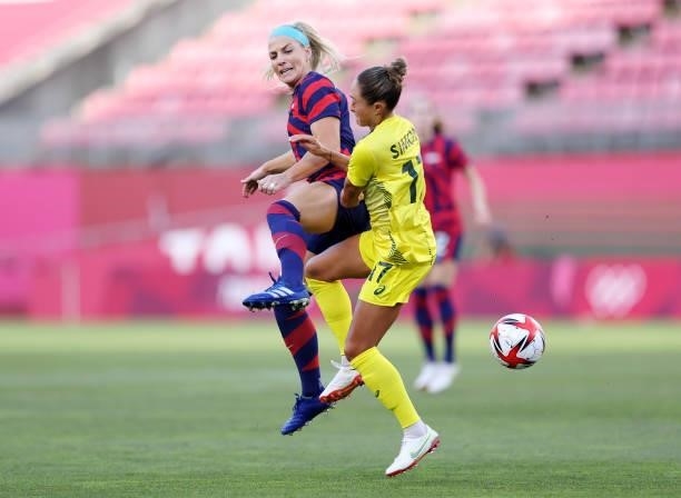 Julie Ertz of Team United States is challenged by Kyah Simon of Team Australia during the Women's Bronze Medal match between United States and...