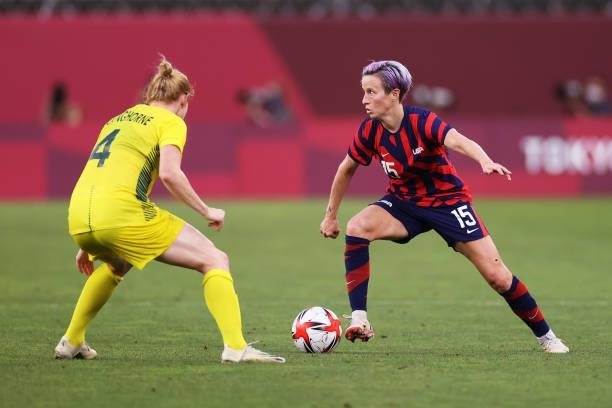 Megan Rapinoe of Team United States on the ball whilst under pressure from Clare Polkinghorne of Team Australia during the Women's Bronze Medal match...