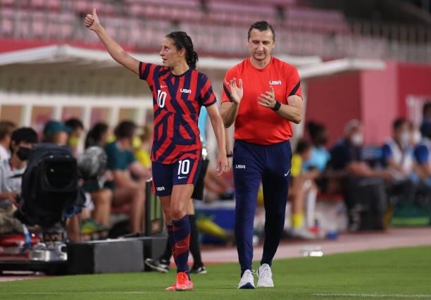 Carli Lloyd of Team United States reacts after being substituted as Vlatko Andonovski, Head Coach of Team United States applauds during the Women's...